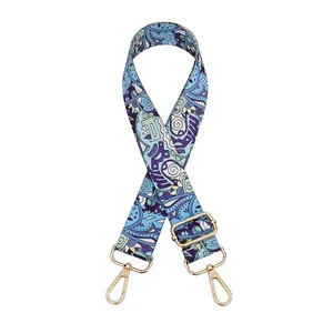 Adjustable wide shoulder strap with blue and purple paisley pattern and gold metal hooks