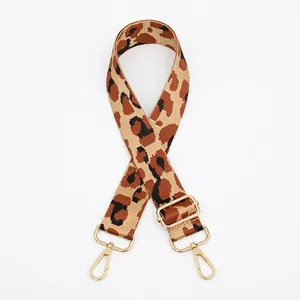 Leopard print wide shoulder strap with golden metal lobster clasps and adjustable buckle