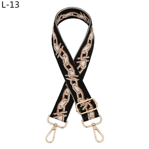 Close-up of adjustable woven shoulder strap with gold metal hooks and chain pattern