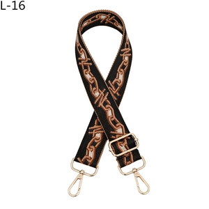 Detail view of woven shoulder strap with geometric chain pattern and gold metal hooks