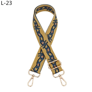 Detail of adjustable geometric patterned bag strap with golden alloy hooks