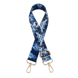 Detail of adjustable blue marble pattern strap with gold metal hooks and buckle