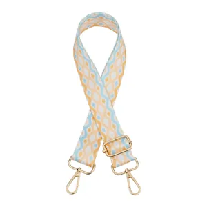 Close-up of bohemian geometric diamond pattern strap with golden metal swivel hooks