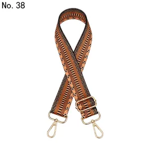 Close-up of geometric ethnic pattern woven strap with gold metal lobster clasps