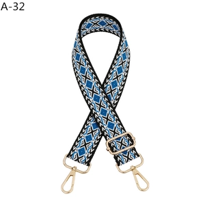 Detail of adjustable woven bag strap with blue and white geometric diamond pattern