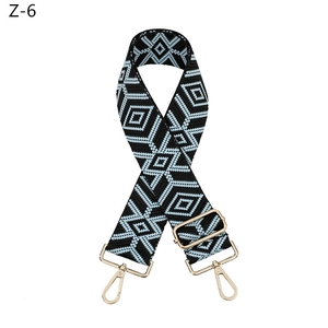 Detail of adjustable geometric diamond pattern bag strap with gold metal hooks