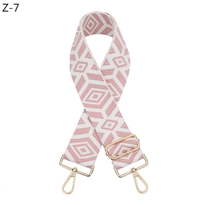 Close-up of pink and grey diamond patterned strap with light gold metal lobster clasps