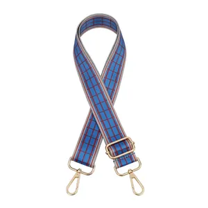 Detail of adjustable woven wide strap with blue stripes and gold lobster clasp