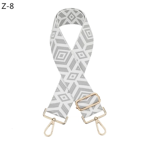 Detail of adjustable geometric diamond pattern shoulder strap with gold metal hooks