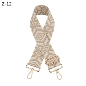 Detail of adjustable rhombus pattern shoulder strap with golden metal swivel hooks