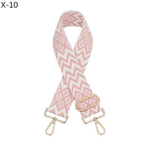 Detail of pink and white geometric jacquard woven strap with golden metal swivel hooks
