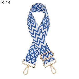 Detail of blue and white geometric jacquard strap with golden lobster clasps and metal buckle