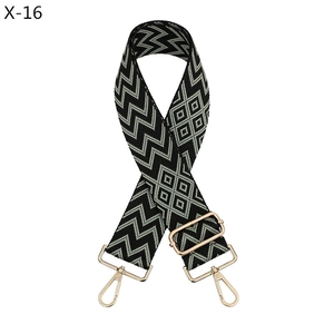 Detail of adjustable bag strap featuring black and grey jacquard geometric pattern