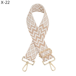 Detail of adjustable beige and white zigzag woven strap with light gold metal hooks