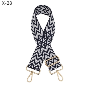 Close-up of jacquard geometric pattern strap with adjustable gold-tone metal hardware