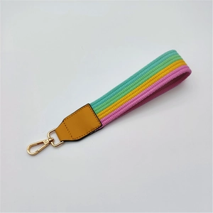 Striped thick fabric wrist strap for handbags with golden metal lobster clasp and yellow leather