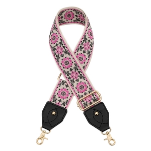 Close-up of pink and black sunflower embroidery on white bohemian style wide bag strap