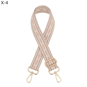 Macro view of adjustable woven shoulder strap with pink geometric jacquard and gold hooks