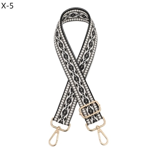 Macro view of black and white geometric ethnic pattern on adjustable woven bag strap
