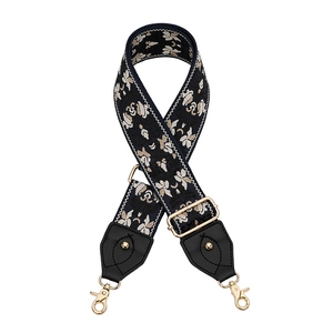 Bandoulière brodée ajustable avec motif floral, embouts en cuir et boucles en métal doré
