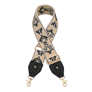 Détail de la bandoulière en jacquard avec motifs floraux dorés et mousquetons en métal