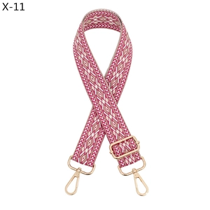 Detail of pink diamond pattern woven strap with gold metal hooks and adjustable buckle