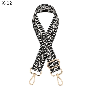 Detail of adjustable black and white geometric jacquard strap with gold metal hooks