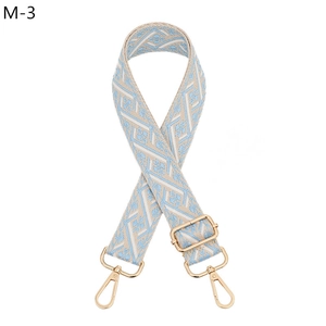Close-up of adjustable light blue jacquard shoulder strap with gold metal hooks