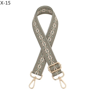 Detail of adjustable woven purse strap with ethnic diamond pattern and gold hardware