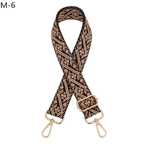 Detail of bohemian ethnic style woven strap with gold metal buckle and lobster clasp