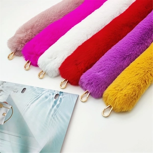 Detail of colorful faux fur bag straps with golden metal swivel hooks and soft plush texture