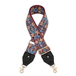 Détail d'une bandoulière tissée réglable à motif ethnique avec mousquetons en métal doré