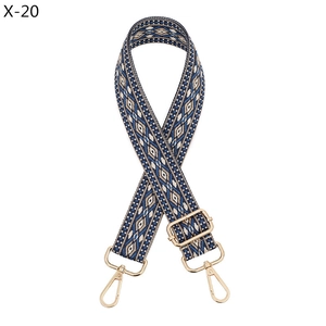 Close-up of geometric diamond pattern shoulder strap with gold metal swivel hooks X-20