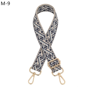 Detail of blue geometric woven strap with gold metal hooks and adjustable buckle
