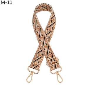 Close-up of ethnic geometric weave bag strap with golden zinc alloy carabiners