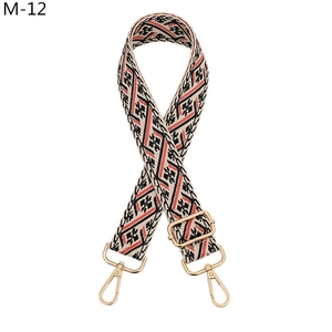 Detail of bohemian geometric pattern woven strap with golden rotating metal buckles