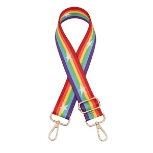 Detail of adjustable rainbow strap with white star pattern and gold metal lobster clasps
