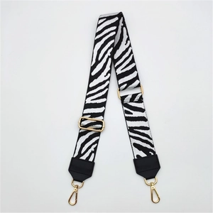 Adjustable zebra print woven shoulder strap with gold hardware and PU leather ends