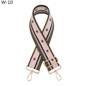 Detail of adjustable star pattern bag strap with premium golden lobster clasps