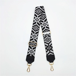 Detail of adjustable PU leather bag strap with black and white geometric woven pattern