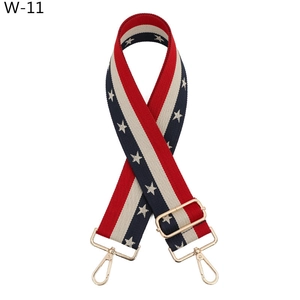 Detail of adjustable star pattern bag strap with gold metal buckles and stripe design