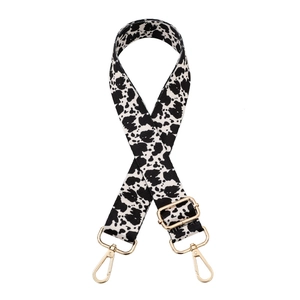 Adjustable wide replacement bag strap with black and white cow print and gold buckles