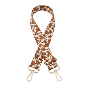 Adjustable crossbody shoulder strap with cow pattern print and gold metal buckles