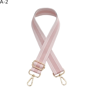 Detail of adjustable pink and white striped bag strap with gold lobster clasps