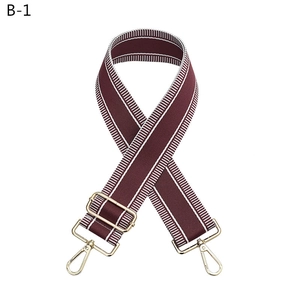 Adjustable burgundy woven bag strap with white stripes and gold metal hardware