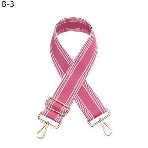 Adjustable rose pink canvas bag strap with white stripes and gold-tone metal hardware