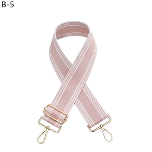 Close-up of pink and white striped fabric strap with adjustable light gold metal hooks