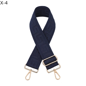 Detail of navy blue wide adjustable bag strap with golden zinc alloy lobster clasps