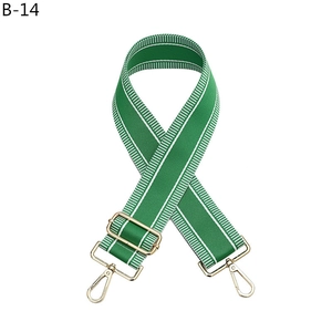 Adjustable green nylon shoulder strap with white stripes and gold metal buckles