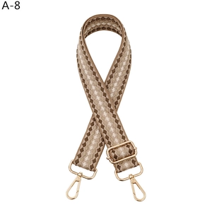 Adjustable wide woven shoulder strap with brown geometric patterns and gold metal clasps
